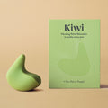 Kiwi therapeutic vibrator for pelvic pain and vaginismus next to its green box in front of a plain peach background