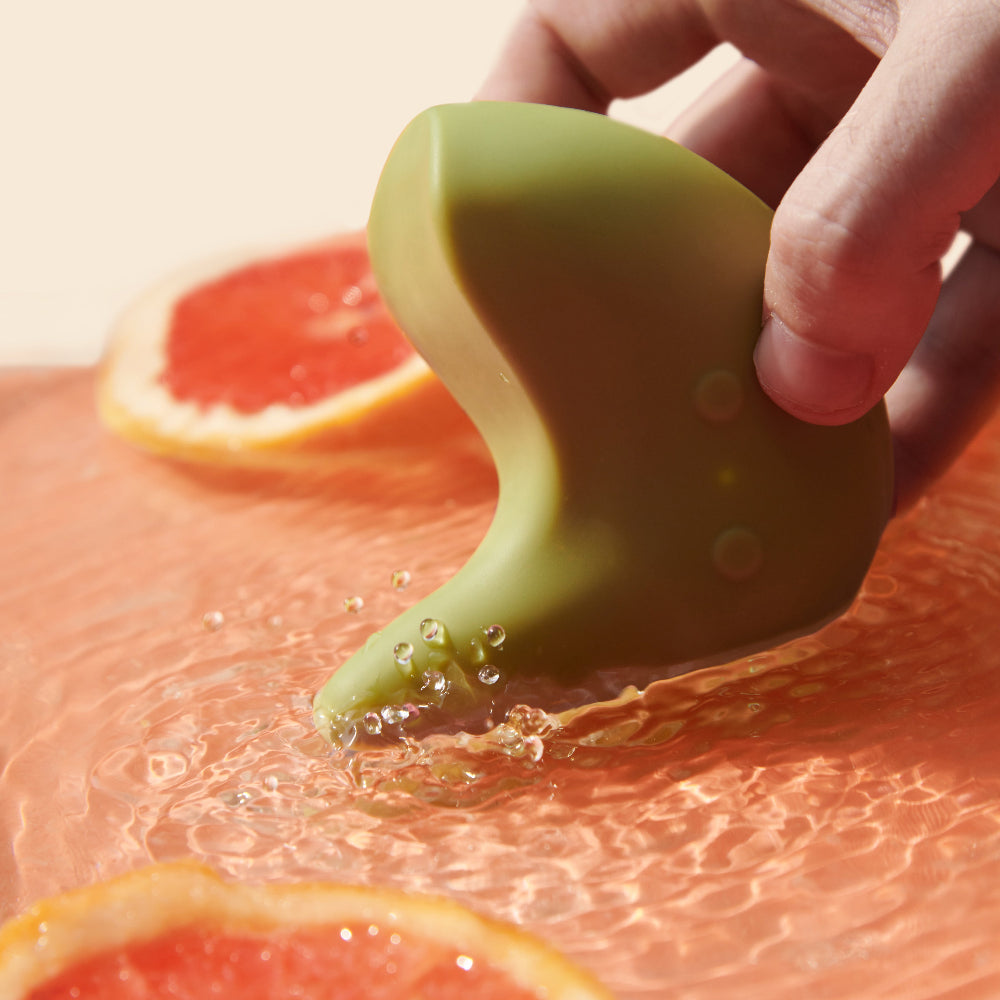 Kiwi vibrator by The Pelvic People vibrating in a shallow pool of water