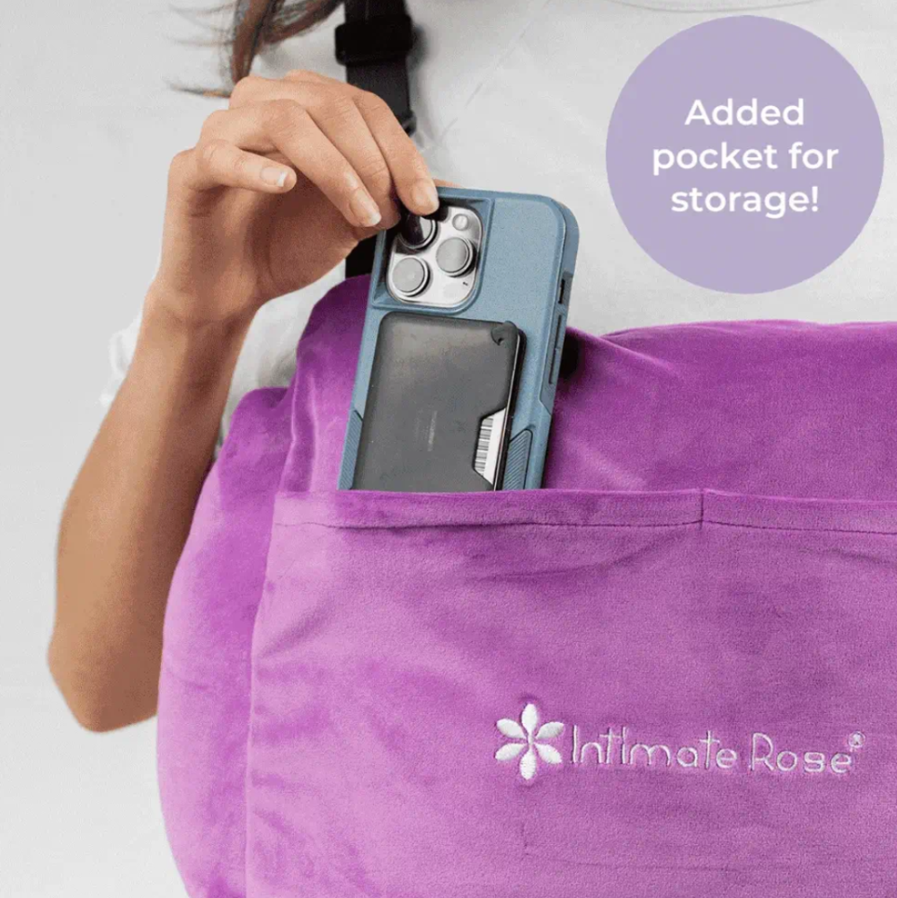 Close up of a woman's hand slipping her mobile phone into the front pocket of her Intimate Rose Mastectomy pillow
