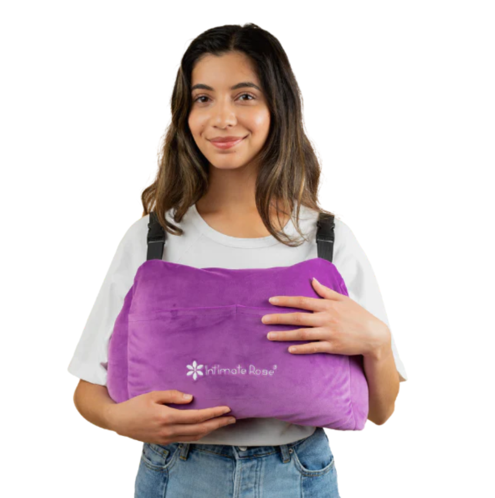 Woman standing while wearing her Intimate Rose mastectomy pillow overe a white tshirt in front of a white background.