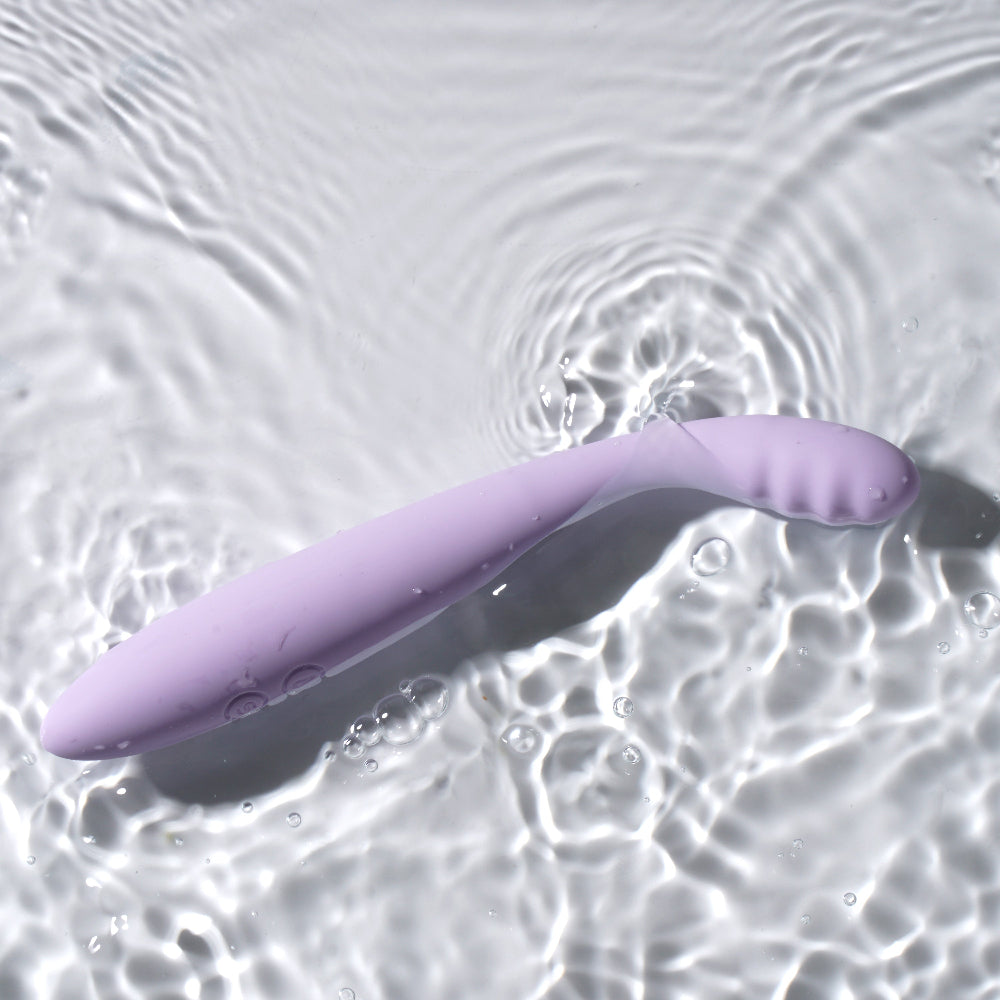 Lifestyle photo of the Svakom Cici 2 reechargeable vibrator in a shallow pool of water to show that it is waterproof